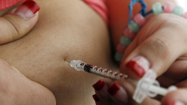 FILE - In this Sunday, April 29, 2012 file photo, a 19-year old diagnosed with diabetes gives herself an injection of insulin at her home in the Los Angeles suburb of Commerce, Calif. The &quot;obesity paradox&quot; — the controversial notion that being overweight might actually be healthier for some people with diabetes — seems to be a myth, researchers report. A major study finds there&#39;s no survival advantage to being large, and a disadvantage to being very large. The study was published by the New England Journal of Medicine on Wednesday, Jan. 15, 2014. (AP Photo/Reed Saxon)