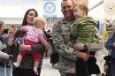 U.S. Air Force airman Lt. Col. Steven Vilpors walks with his wife Joanna and children Connor and Alina as he arrives in Baltimore Washington International Airport, Maryland