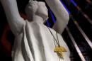 An accessory featuring a yellow umbrella hangs on a Goddess of Democracy statue at the June 4th Museum in Hong Kong