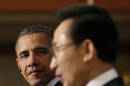 U.S. President Barack Obama, left, looks at South Korean President Lee Myung-bak during their joint news conference at the presidential Blue House in Seoul, South Korea, Sunday, March 25, 2012. (AP Photo/Pablo Martinez Monsivais)
