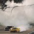 Kurt Busch (22) leaves a plume of smoke as Denny Hamlin (11) passes by during the NASCAR Sprint Cup Series auto race at Richmond International Raceway in Richmond, Va., Saturday Sept. 10, 2011. (AP Photo/Clem Britt)