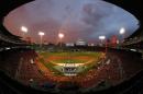 IN this image taken with a fisheye lens, Boston Red Sox players take batting practice as a rainbow appears in the sky above Fenway Park Tuesday, Oct. 22, 2013, in Boston. The Red Sox are scheduled to host the St. Louis Cardinals in Game 1 of baseball's World Series on Wednesday. (AP Photo/Elise Amendola)
