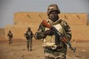Soldiers from Niger patrol in an open field in Gao