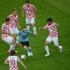 Spanish midfielder Andres Iniesta (centre) drives the ball surrounded by Croatian players