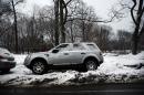 An SUV is parked on a mound of snow and ice along a road on February 18, 2014 in Brooklyn borough of New York City