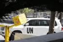 A U.N. vehicle returns to a hotel where experts from the Organisation for the Prohibition of Chemical Weapons (OPCW) are staying, in Damascus
