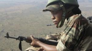 A female Cameroonian soldier stands guard at an observation post on a hill in the Mandara Mountain chain in Mabass, overlooking Nigeria, northern Cameroon