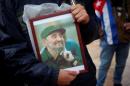 A supporter holds an image of former Cuban leader Fidel Castro at a tribute in Malaga, southern Spain. (Reuters)