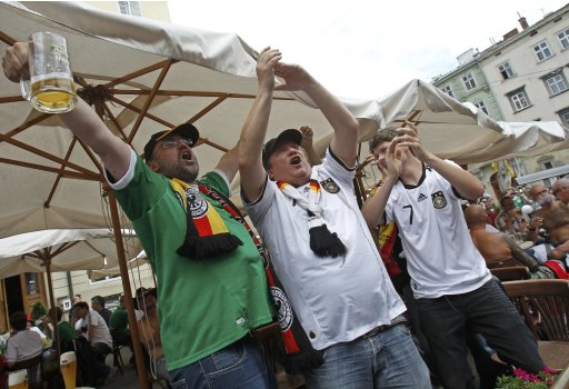 German soccer fans drink beer and sing in central Lviv