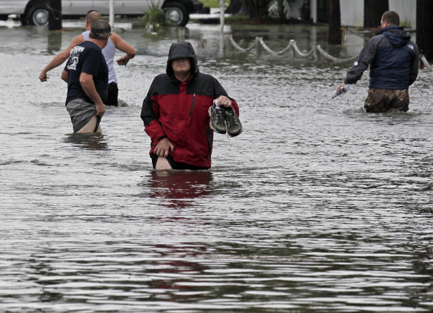 Bill Provensal carries his shoes while wading through the flood waters caused by Tropical Storm Lee in New Orleans, Saturday, Sept. 3, 2011. Heavy rains from Tropical Storm Lee were falling in southern Louisiana and pelting the Gulf Coast on Saturday as the storm's center trudged slowly toward land. (AP Photo/Bill Haber)