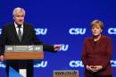 Horst Seehofer, party leader of the Christian Social Union Party (CSU) and Bavarian State Premiere, thanks German Chancellor Angela Merkel (R) after her speech during the CSU party congress in Munich, southern Germany on November 20, 2015