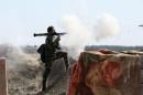 An Iraqi soldier launches a rocket-propelled grenade towards Islamic State militants, west of Falluja