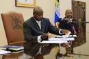 Uganda's President Yoweri Museveni signs an anti-homosexual bill into law at the state house in Entebbe