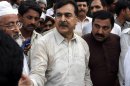 People visit Pakistan's former Prime Minister Yousuf Raza Gilani, center, at his residence in Multan, Pakistan, Thursday, May 9, 2013. Gunmen attacked an election rally in Pakistan's southern Punjab province on Thursday and abducted Ali Haider Gilani, son of a former prime minister, intensifying what has already been a violent run-up to Saturday's nationwide elections. (AP Photo/Zeeshan Hussain)