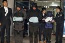 Lee Joon-seok, third from left, the captain of the ferry Sewol that sank off South Korea, and two crew members prepare to leave a court which issued their arrest warrant in Mokpo, south of Seoul, South Korea, Saturday, April 19, 2014. The captain of the sunken ferry, leaving more than 300 missing or dead, was arrested early Saturday on suspicion of negligence and abandoning people in need. Two crew members also were taken into custody, including a mate who a prosecutor said was steering in challenging waters unfamiliar to her when the accident occurred. (AP Photo/Yonhap) KOREA OUT