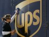 FILE - In a Jan. 25, 2007 file photo Brandy Goggin polishes a UPS sign on a UPS truck in New Orleans.  United Parcel Service Inc. said Monday March 19, 2012, it has agreed to buy TNT Express NV for $6.77 billion (€5.16 billion).  (AP Photo/Bill Haber/file)