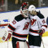 New Jersey Devils goalie Martin Brodeur (30) and Travis Zojac (19) celebrate their 3-2 win over the Florida Panthers in Game 1 of an NHL hockey Stanley Cup first-round playoff series in Sunrise, Fla., Friday, April 13, 2012. (AP Photo/J Pat Carter)