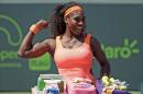 RETRANSMISSION TO CORRECT 400TH to 700TH WIN - Serena Williams poses with a cake celebrating her 700th career win after she defeated Sabine Lisicki during their quarterfinal match at the Miami Open tennis tournament, Wednesday, April 1, 2015, in Key Biscayne, Fla. Williams won the match 7-6 (4), 1-6, 6-3. (AP Photo/Lynne Sladky)
