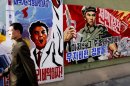 A man walks past propaganda posters in Pyongyang, North Korea on March 26.