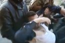 This image made from amateur video and released by Shaam News Network Tuesday, March 27, 2012, purports to show a Syrians carrying a wounded man in Homs, Syria. Syrian activists said Wednesday a government offensive in northern Syria during which troops overran a major opposition stronghold has left behind scenes of destruction, with corpses in the streets, homes burned to the ground and shops that have been pillaged and looted. (AP Photo/Shaam News Network via APTN) THE ASSOCIATED PRESS CANNOT INDEPENDENTLY VERIFY THE CONTENT, DATE, LOCATION OR AUTHENTICITY OF THIS MATERIAL. TV OUT