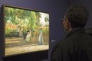 A visitors looks at the painting ''After Lunch" (La Pergola),1868, by Silvestro Lega, at the Orangerie Museum in Paris, Tuesday April 9, 2013. A new exhibit at Paris' Orangery museum called 