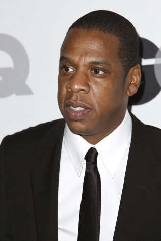 FILE - In this Nov. 17, 2011 file photo, Jay-Z arrives at the 16th annual GQ "Men of the Year" party in Los Angeles. Michael Eric Dyson parses Jay-Z?s lyrics as if analyzing fine literature. The rapper?s riffs on luxury cars and tailored clothes and boasts of being the ?Mike Jordan of recording? may make for catchy rhymes, but to Dyson, they also reflect incisive social commentary. Dyson, a professor, author, radio host and television personality, has offered at Georgetown University this semester a popular _ if unusual _ class dedicated to Jay-Z and his career. (AP Photo/Matt Sayles, File)
