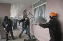 Pro-Russian men storm a police station in the eastern Ukrainian town of Horlivka on Monday, April 14, 2014. Several government buildings have fallen to mobs of Moscow loyalists in recent days as unrest spreads across the east of the country. (AP Photo/Efrem Lukatsky)