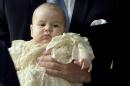 Britain's Prince William carries his son Prince George as they arrive for his son's christening at St James's Palace in London