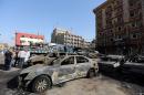 Iraqis inspect the site of a suicide bomb attack in Baghdad's Battaween district on September 29, 2015
