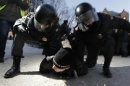 Police officers detain an opposition activist during an unauthorised rally in central Moscow