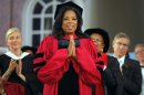 Media mogul Winfrey acknowledges the cheers from students and audience as she receives an honorary Doctor of Laws degree during Harvard University's 362nd Commencement Exercises in Cambridge