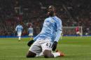 Manchester City's Yaya Toure celebrates after scoring against Manchester United during their English Premier League soccer match at Old Trafford Stadium, Manchester, England, Tuesday, March 25, 2014. (AP Photo/Jon Super)