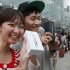Kae Shibata 20, left, and Yutaro Noji, 21, show off Apple's iPhone 5 after they bought at a store in Tokyo Friday morning, Sept. 21, 2012. (AP Photo/Koji Sasahara)