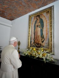 This handout picture released by the Vatican Press Office shows Pope Benedict XVI praying in front of an image of the Virgin of Guadalupe at the chapel of Miraflores College in the city of Leon, Guanajuato State, Mexico. (AFP Photo/)