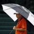 Harrison Frazar carries an umbrella in the rain as he walks on the 17th hole during the first round of The Barclays golf tournament in Edison, N.J., Thursday, Aug. 25, 2011. (AP Photo/Mel Evans)