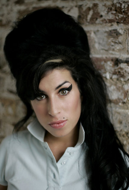 FILE - In this Feb. 16, 2007 file photo, British singer Amy Winehouse poses for photographs at a studio in north London. Winehouse, the beehived soul-jazz diva whose self-destructive habits overshadow