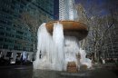 A fountain partially frozen into ice is seen at Bryant Park in New York
