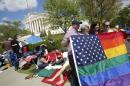 People line up outside the Supreme Court in Washington ahead of Tuesday's arguments focusing on gay marriage
