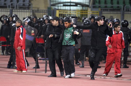 Egyptian police arrest a soccer fan at Port Said Stadium