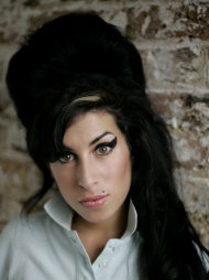 FILE - In this Feb. 16, 2007 file photo, British singer Amy Winehouse poses for photographs at a studio in north London. Winehouse, the beehived soul-jazz diva whose self-destructive habits overshadowed a distinctive musical talent, was found dead Saturday, July 23, 2011, in her London home, police said. She was 27. (AP Photo/Matt Dunham, File)