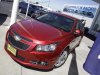 FILE - In this Aug. 30, 2011 file photo a 2011 Chevrolet Cruze is featured at a car dealership in San Jose, Calif. General Motors Co. said Thursday, Feb. 16, 2012, it made more money in 2011 than any year in its history.  (AP Photo/Paul Sakuma)