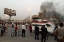 Iraqi police gather at the site of a car bomb in the Talibiya district of Baghdad, on September 3, 2013