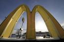 In this Tuesday, Jan. 21, 2014, photo, cars drive past the McDonald's Golden Arches logo at a McDonald's restaurant in Robinson Township, Pa. McDonald's reports quarterly earnings on Thursday, Jan. 23, 2014. (AP Photo/Gene J. Puskar)