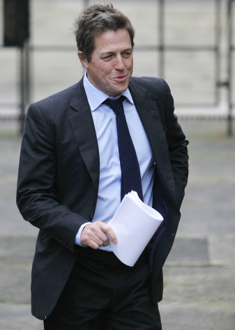 FILE - A Monday Nov. 21, 2011 photo from files showing British actor Hugh Grant arriving to give evidence at the the Leveson inquiry in London. J.K Rowling described how press intrusion made her feel like a hostage, Hugh Grant traded insults with a newspaper editor and a former tabloid reporter insisted that only evildoers had any need of privacy. The first phase of Britain's media ethics inquiry ended this week after 40 days of dramatic hearings that heard from 184 witnesses _ celebrities, journalists, editors, academics and lawyers _ and revealed wildly differing perspectives on the murky workings of the tabloid press. (AP Photo/Alastair Grant, File)