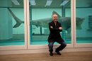 British artist Damien Hirst poses for photographers beside the 1991 piece 