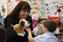 In this April 3, 2012, photo, teacher Bev Campbell, left, holds up stuffed animals in front of student Sebastian Rodriguez in her special education class at Amelia Earhart Elementary School in Hialeah, Fla. More than a dozen states have passed laws to reform how teachers are evaluated and include student growth as a component. For special education students measuring that growth is complicated. (AP Photo/Lynne Sladky)