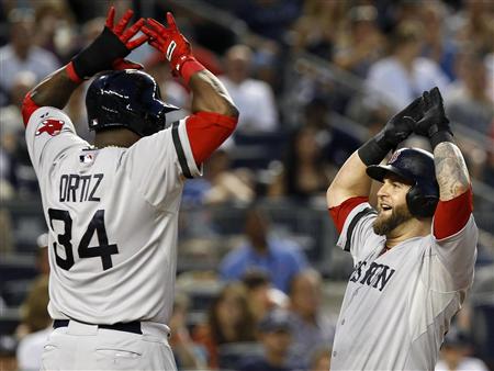 Boston Red Sox's Mike Napoli (R) celebrates his grand slam home run with teammate David Ortiz against the New York Yankees during the third inning of their MLB American League baseball game at Yankee Stadium in New York, June 1, 2013. REUTERS/Adam Hunger