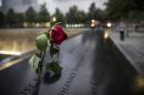 A wilting rose is left in remembrance of those lost before the memorial observances held at the site of the World Trade Center in New York