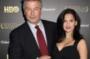 FILE - In this Oct. 24, 2013 file photo, producer and actor Alec Baldwin and wife Hilaria Baldwin attend the HBO premiere of "Seduced and Abandoned" at The Time Warner Center, in New York. Baldwin is putting a twist on his rocky relationship with the media: He's playing a meddling newspaperman on a NBC drama. The network said Tuesday, Feb. 25, 2014, that Baldwin guest stars as a New York columnist on "Law & Order: Special Victims Unit," airing March 19, 2014. (Photo by Greg Allen/Invision/AP, file)