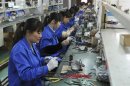 Employees make circuit boards at an electronic component factory in Hefei